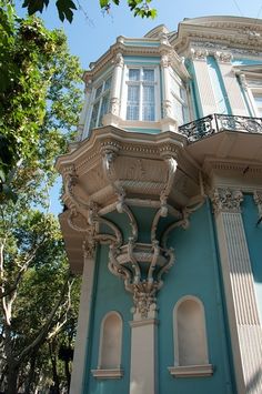 an ornate blue and white building with balconies