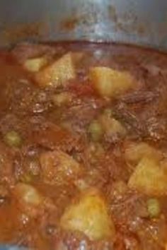 a pot filled with food sitting on top of a stove