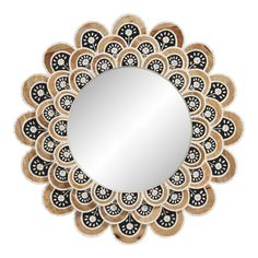 a decorative mirror with black and white designs on the bottom, in front of a white background