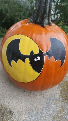 a pumpkin with a bat painted on it