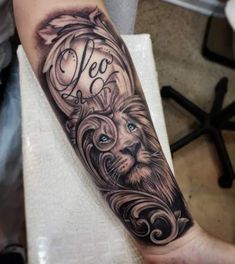 a man's arm with a lion and the word leo on it, in black ink