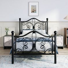 a black metal bed frame in a white bedroom