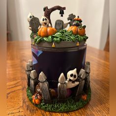 a cake decorated with halloween decorations on top of a wooden table