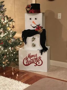 a snowman on top of a white box in front of a christmas tree