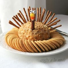 a plate topped with crackers and a turkey made out of crackers on top of it