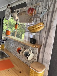 a kitchen area with a sink, stove and counter top next to a large window