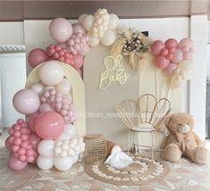 balloons and teddy bears are arranged in front of a backdrop for a baby's first birthday