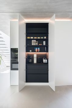 an open cabinet in the middle of a room