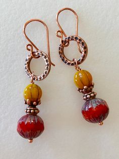 "Gorgeous burnt orange silk Picasso 11 x 10 mm glass beads with faceted carved ends and rustic burnt orange centers. Premium Czech glass beads together with canary yellow gold fluted mini pumpkins or melon beads with copper Picasso etching. Beads are wire wrapped with detailed beaded copper spacers and bead caps on 1/2\" hammered copper rings. These metal components are by Tierracast made in USA. Handmade copper ear wires. Earrings have a total drop of 2\". Perfect fall accessory!" Beaded Earrings Diy, Aquamarine Earrings, Pumpkin Earrings, Earrings Diy, Fall Earrings, Boho Fall, Mini Pumpkins, Canary Yellow, Fall Accessories