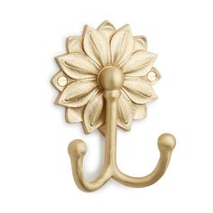 a gold metal hook with a flower on it