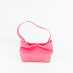 Soft leather baguette bag that transforms into a clutch via a removable strap. Versatile Evening Bag In Pebbled Leather, Pink Leather Evening Bag With Detachable Strap, Versatile Evening Shoulder Bag In Pebbled Leather, Versatile Pebbled Leather Evening Shoulder Bag, Formal Pink Leather Baguette Bag, Pink Leather Baguette Bag With Removable Pouch, Everyday Textured Leather Top Handle Baguette Bag, Modern Pink Textured Leather Bag, Modern Pink Leather Baguette Bag