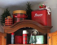 a shelf with christmas presents and tins on it