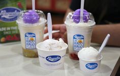 three ice cream sundaes sitting on top of a table