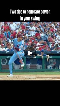 a baseball player pitching a ball while standing on top of a field in front of a crowd