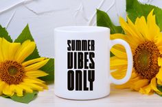 a white coffee mug with the words summer vibes only on it next to sunflowers