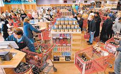 people shopping in a store filled with lots of items