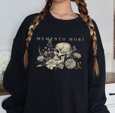 Keep your Halloween classy with this Memento Mori Skull and Flowers sweatshirt. Perfect gift for him or her.  Crafted from a soft blend of 50% cotton and 50% polyester. Features air jet yarn for a softer feel and reduced pilling. Double-needle stitching at shoulder, armhole, neck, waistband, and cuffs. 1x1 rib with spandex for enhanced stretch and recovery. Classic fit for everyday comfort. Manufacturer contact information Name: Printful Email address: support@printful.com Postal address: Raina Dark Academia Skull, Romantic Halloween, Goth Cottagecore, Flower T Shirt, Perfect Gift For Him, She & Him, Halloween Sweatshirt, Memento Mori, Pressed Flower