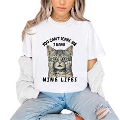 A funny and witty Unisex Short Sleeve Tee perfect for animal lovers and cat moms. The design 'You Can't Scare me I Have Nine lives' adds a playful vibe to any outfit. Ideal for casual wear, layering, and as a gift for cat enthusiasts. Relevant for birthdays, holidays, and everyday wear. Product features - Breathable 100% Airlume combed and ring-spun cotton - Retail fit for casual and semi-formal settings - Side seams for structural support - Ribbed knit collar for shape retention - Humane and su Cat Mom Gifts, Nine Lives, Cat Tee, You Can, Funny Animal, Jersey Tee, Unisex Shorts, Cat Tshirt, Cat Mom