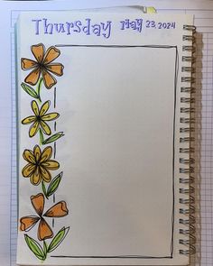 an open spiral notebook with flowers drawn on it and the words, thursday may 23, 2014