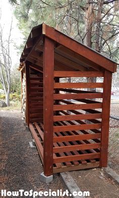 a small wooden shelter in the woods