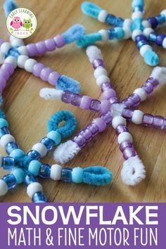 beads are arranged in the shape of a snowflake on a wooden table top