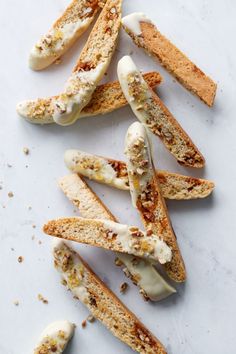 several pieces of bread with white icing on them