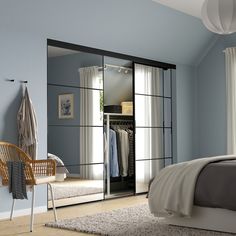 a bedroom with blue walls and white furniture