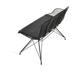 a black chair sitting on top of a metal frame