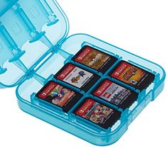 a blue case with six games in it on a white surface and the lid is open