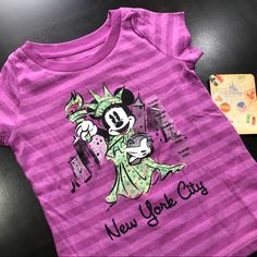 Disney Minnie Baby Girl New York City Short Sleeves T-Shirt New With Tag Disney Store 60%Cotton, 40% Polyester From A Pet Free And Smoke Free Environment Nyc Baby, Baby Girl Shorts, City Shorts, Disney Store, Short Girls, Kids Shirts, Pink And Green, York City, New York City