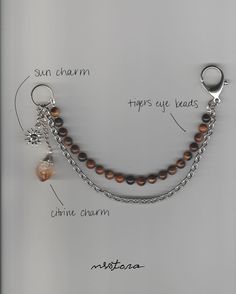 a necklace with charms attached to it and labeled on the bottom side, along with instructions for how to wear them