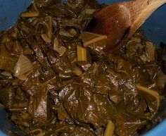 a wooden spoon in a blue bowl filled with food