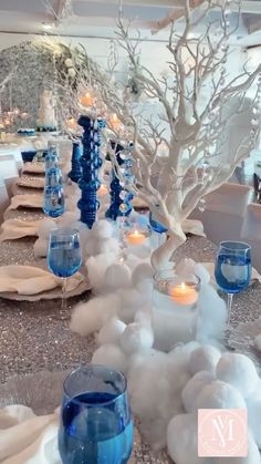 the table is set with blue and white decorations