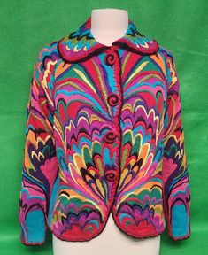 a brightly colored jacket on a white mannequin