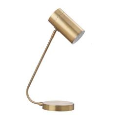 a gold desk lamp on a white background