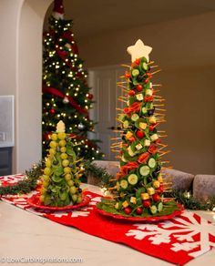 two christmas trees made out of fruits and veggies are sitting on a table