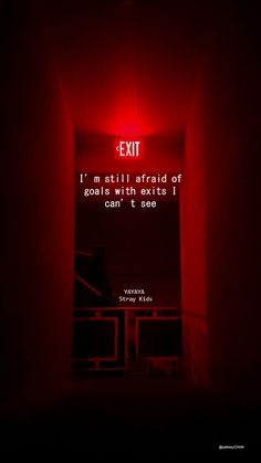 an exit sign lit up in the dark with a red light above it that reads, i'm still afraid of good intentions