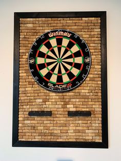 a dart board mounted to the side of a brick wall