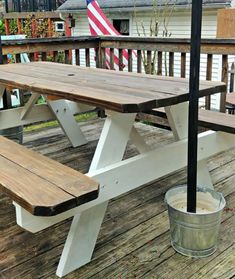 a picnic table with an american flag in the background