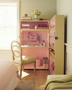 there is a pink and yellow dollhouse in the room with its bed, desk, chair, dresser and mirror