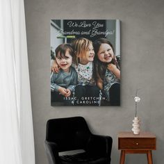 a black chair in front of a gray wall with a poster on it that says, we are love you grandma and grandma