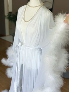 Long bridal sheer marabou feather robe with satin sash. Comes in both white and ivory! White is shown in the first photo and ivory in the others.  Beautiful for boudoir, bridal and maternity shoots! Also just nice for a romantic night, getting ready or lounging at home!  PLEASE MSG ME YOUR HEIGHT IF YOU REQUIRE TALLER THAN 5'8" WITH HEELS/SHOES Comes in all colors and sizes (message for info). All of these are handmade to order. For custom color requests please allow time for me to get materials Sheer Robe With Fur, Robe With Fur, Fur Aesthetic, Maternity Shoots, Sheer Robe, Bridal Robe, Satin Sash, Feather Trim, Romantic Night