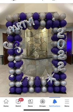 the balloon arch is decorated with silver and purple balloons