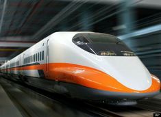 a white and orange train traveling through a station with lots of lights on it's sides