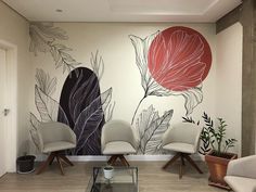 a living room with two chairs and a wall mural