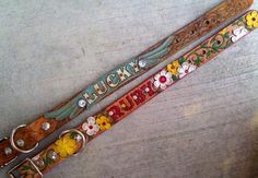 two colorful dog collars with flowers and the words lucky written on them are sitting next to each other