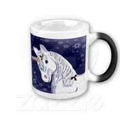 a coffee mug with a white horse on it's face and snowflakes in the background