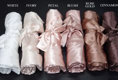 six different colors of satin ribbons on a black surface with white, ivory, pink, peach, and rose gold