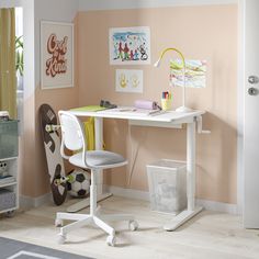 a room with a desk, chair and pictures on the wall above it is decorated in pastel colors