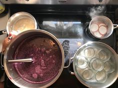 two pans filled with food cooking on top of an electric burner stovetop